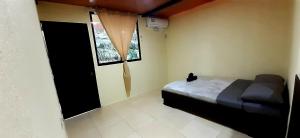 a bedroom with a black cat sitting on a bed at Natural Manzanillo in Manzanillo