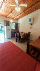 a kitchen and dining room with a table and a refrigerator at Monoambiente amplio con pileta in Cosquín