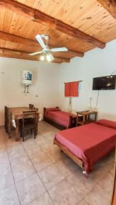 a bedroom with two beds and a ceiling fan at Monoambiente amplio con pileta in Cosquín
