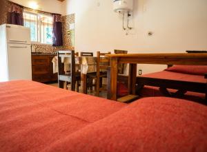 a kitchen and dining room with a table and a refrigerator at Monoambiente amplio con pileta in Cosquín +8 photos