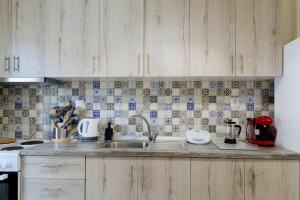 a kitchen with a sink and a counter top at Stefias Apartment in Kallithéa