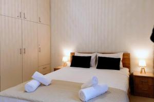 a bedroom with two beds with towels on them at Stefias Apartment in Kallithéa