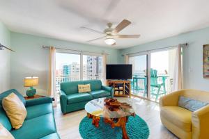 a living room with a couch and chairs and a table at Anglers Cove 602 in St. Pete Beach