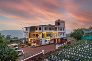 an aerial view of a house with a parking lot at Strawberry King Resort in Mahabaleshwar
