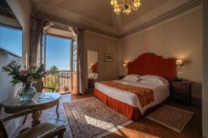 Postel nebo postele na pokoji v ubytování Palazzo Leopoldo Dimora Storica & Spa