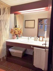 a bathroom with a sink and a mirror at Casa da Lagoa BB or HB options in Santana +30 photos