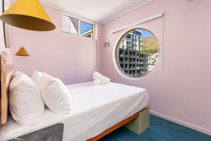 a bedroom with a bed with a round window at The Tropicana Hotel in Cape Town +105 photos