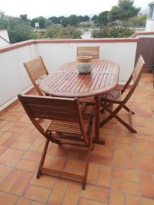 a wooden table and chairs on a patio at Lydia in Port Leucate