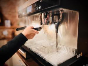 a person is putting something in an oven at Jugendherberge City-Hostel Köln-Riehl in Cologne