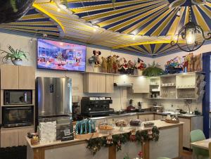 a kitchen with a television and a kitchen with a counter at Hotel Colibri Real in Filandia