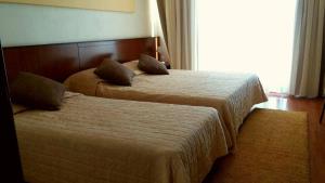 Ένα ή περισσότερα κρεβάτια σε δωμάτιο στο Ξενοδοχείο Ακροπόλ