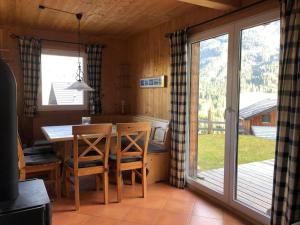 a kitchen with a table and chairs and a sliding glass door at Chalet in traumhafter Lage im Wanderparadies in Annaberg im Lammertal