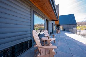 two chairs sitting on the porch of a house at Cove Creek Lodge 203 Poolside Double Queen Room in Oakland