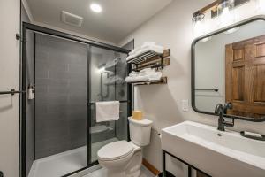 a bathroom with a shower and a toilet and a sink at Cove Creek Lodge 203 Poolside Double Queen Room in Oakland