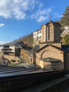 a building with a church on top of a hill at Апартамент за гости ''ЗДРАВЕ'' in Kyustendil