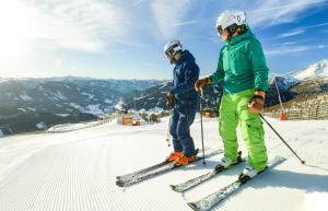 two people on skis on top of a ski slope at Landal Katschberg in Rennweg +21 photos