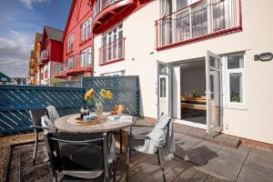 a patio with a table and chairs on a balcony at Anchors Away in Exmouth