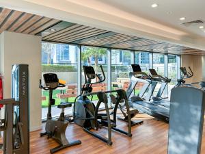 a gym with treadmills and elliptical machines at Burj KHALIFA VIEW SMART HOME ZADA TOWER in Dubai