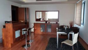 a living room with a piano and a table and chairs at Acropol Hotel in Serres