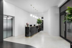 korytarz z białymi ścianami oraz czarno-biały hol w obiekcie Hotel Beránek w Pradze