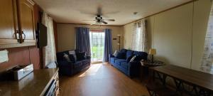 a living room with two blue couches and a table at The Beach House in Hillsboro