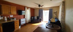 a living room with a couch and a chair at The Beach House in Hillsboro +2 photos