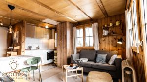 a living room with a couch and a kitchen at Ferienhaus Golmenheim, Riederalp in Riederalp