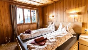 a bedroom with two beds and a window at Ferienhaus Golmenheim, Riederalp in Riederalp