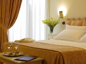 a bedroom with a bed with two glasses on a table at Locanda Del Parco Hotel in Colledara +30 photos