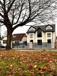 a large house with a tree in front of it at Bel Casa Solihull in Solihull