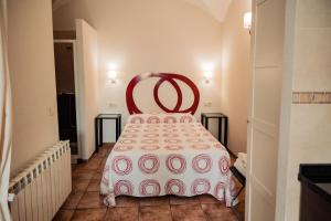 a room with a bed with a red chair in it at Apartamento Las Avutardas 1 in Cáceres