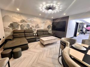 a large living room with a couch and a tv at Bel Casa Solihull in Solihull