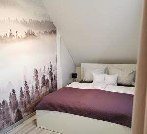 a bedroom with a bed with a forest wall mural at Messzikék in Egerszalók +44 photos