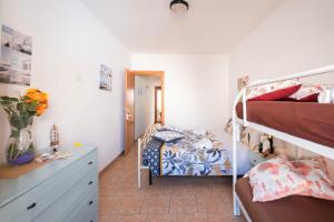 a bedroom with two bunk beds and a desk at On The Beach San Foca in San Foca