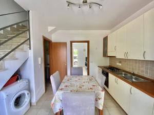 a small kitchen with a table and a sink at Isca Dreams T6 in Isca sullo Ionio