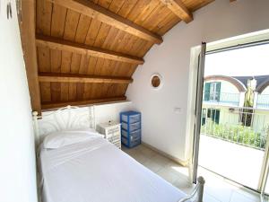 a bedroom with a bed and a large window at Isca Dreams T6 in Isca sullo Ionio +29 photos
