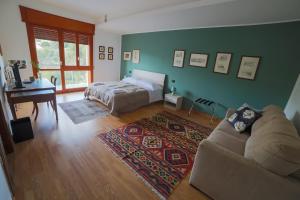 a bedroom with a bed and a couch and a table at A Casa di Sara in Castrovillari