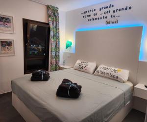 two bags sitting on a bed in a room at Apartamento Yumbo Iguazu Luxury in Maspalomas +64 photos