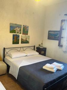 a bedroom with a bed with towels on it at Mani Spot center in Areopoli