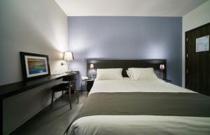 a bedroom with a large bed and a desk at Smart Hotel in Carpi