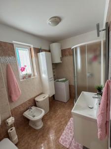 a bathroom with a toilet and a shower and a sink at Neva in Novigrad Istria +24 photos
