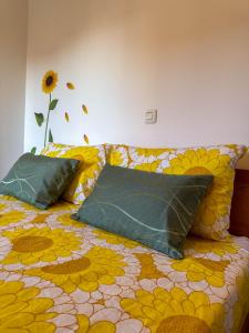 a bed with two pillows on it with a flower pattern at Neva in Novigrad Istria