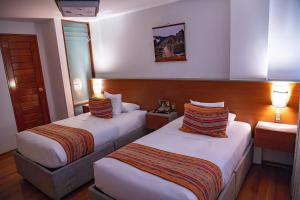 Postel nebo postele na pokoji v ubytování Chakana Hotel Machupicchu