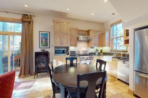 a kitchen with a wooden table and a dining room at Cottage Charms in South Lake Tahoe
