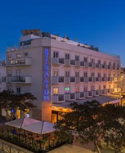 a hotel with a sign on the side of it at Hotel Baltum in Albufeira