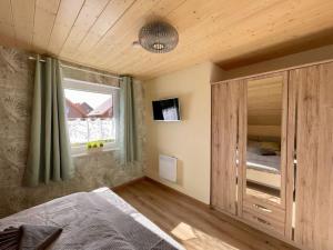 a bedroom with a large bed and a window at Ferienhaus Christel in Hasselfelde