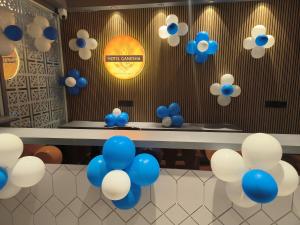 a table with blue and white balloons on the wall at Hotel Ganesha - residential in Muzaffarpur +28 photos