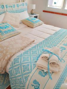 a bedroom with two beds with towels on them at Villa Anna 300 m dal mare in Torre delle Stelle