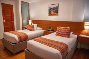 Postel nebo postele na pokoji v ubytování Ausangate Hotel Machupicchu + 14 fotografií