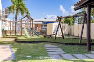 a park with a playground with a slide at Apto Cond Vog, Ilhéus, a 5 Min da Praia! - VTL0103 in Pontal